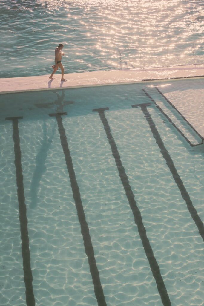 pexels photo 4142815 Aerial view of Bondi Icebergs Pool with a man walking along its edge during a golden sunset.